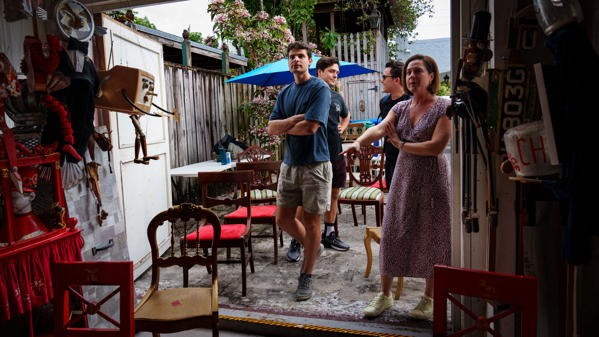 Street scene with vintage cars and pastel storefronts